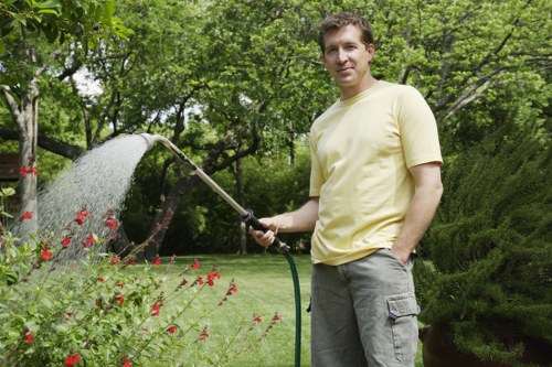 Gardening staff using PPE during a maintenance task